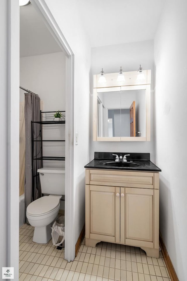 full bathroom with tile patterned flooring, shower / tub combo with curtain, vanity, and toilet