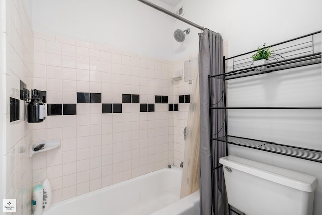 bathroom with shower / tub combo and toilet