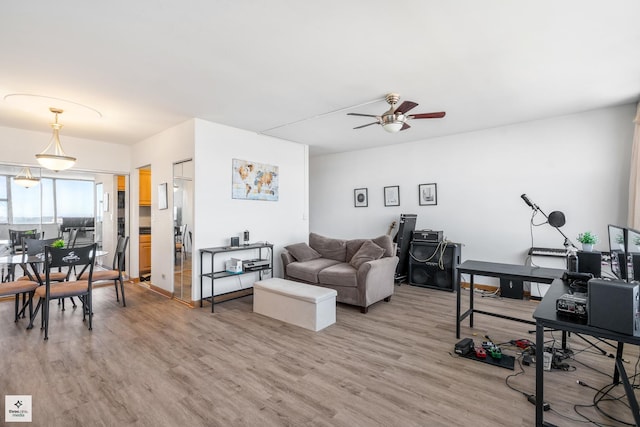 living room featuring hardwood / wood-style floors and ceiling fan