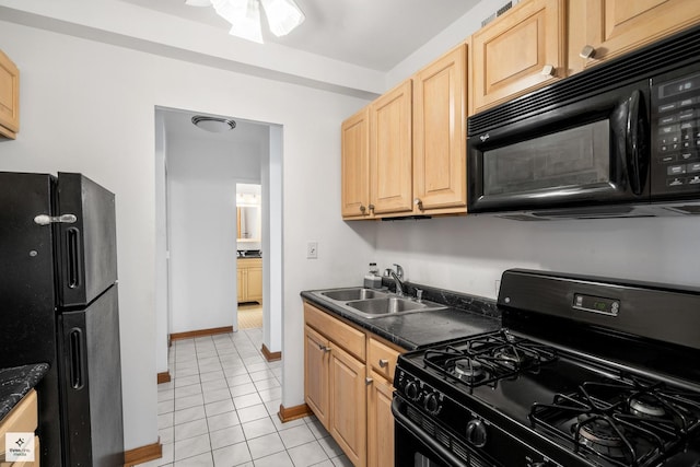 kitchen featuring light tile patterned flooring, light brown cabinetry, sink, and black appliances