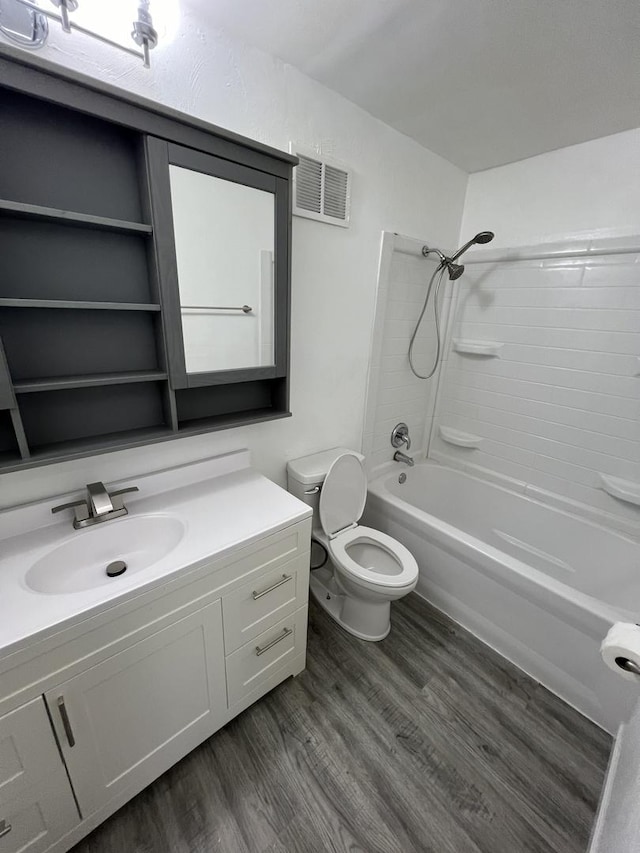 full bathroom with vanity, toilet, wood-type flooring, and tub / shower combination