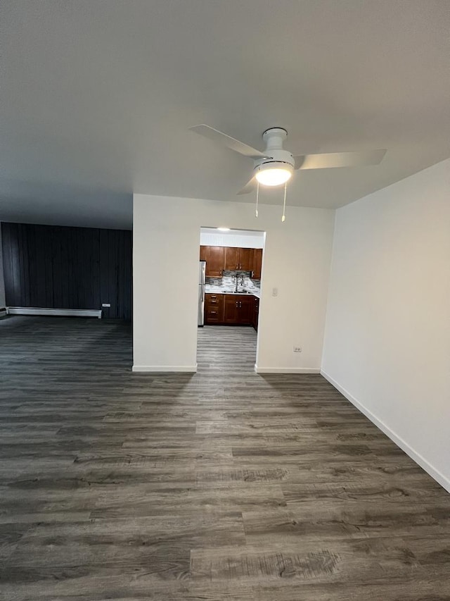 unfurnished room with ceiling fan and dark hardwood / wood-style flooring