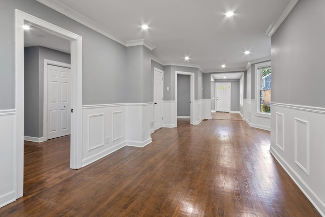 interior space with dark wood-type flooring and ornamental molding