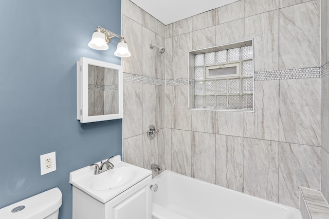 full bathroom featuring toilet, vanity, and tiled shower / bath combo