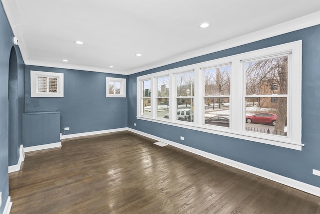 unfurnished room with ornamental molding and dark hardwood / wood-style flooring