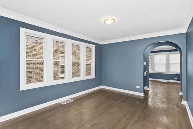 empty room with crown molding and dark hardwood / wood-style floors