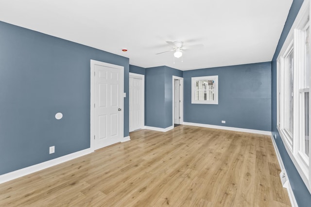 empty room featuring light wood-type flooring and ceiling fan