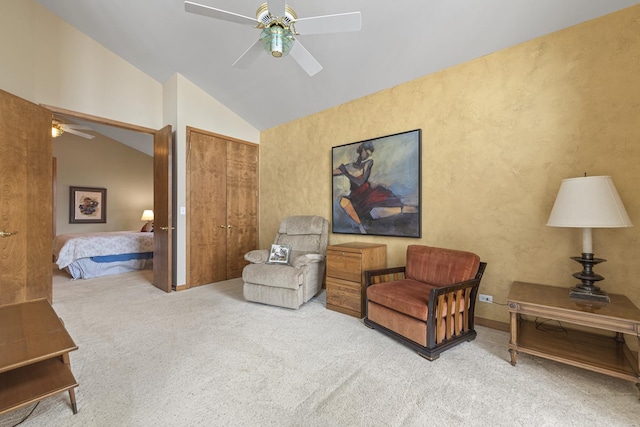 living area with carpet flooring, vaulted ceiling, and ceiling fan