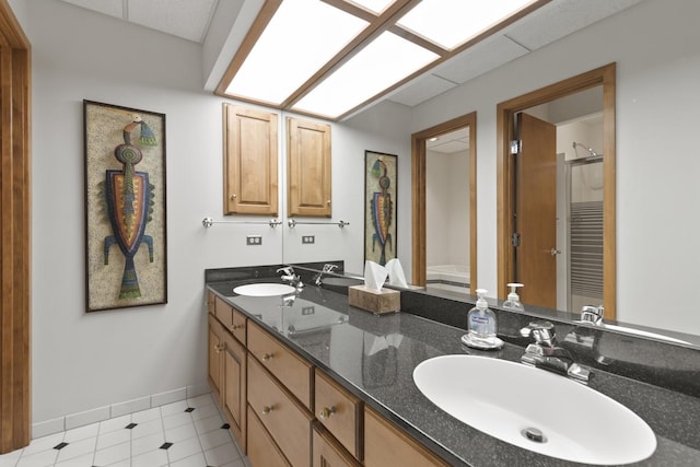 bathroom with tile patterned floors and vanity