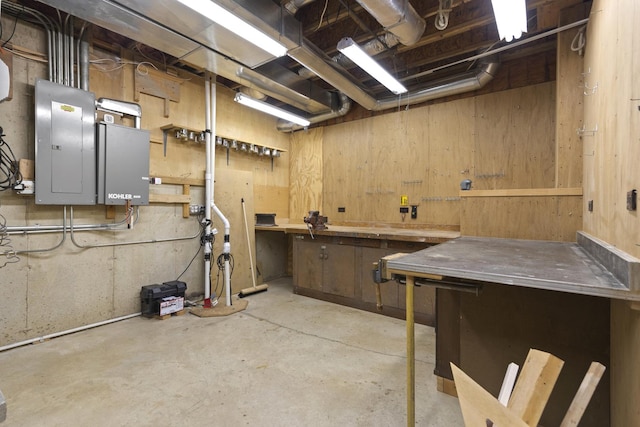 basement with a workshop area and electric panel