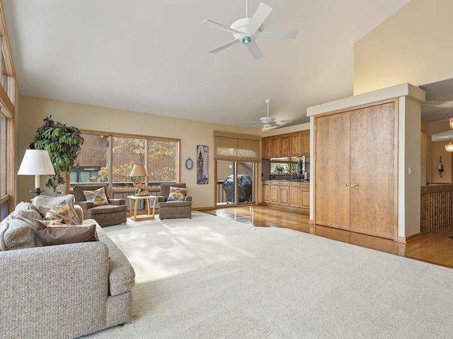 carpeted living room with ceiling fan