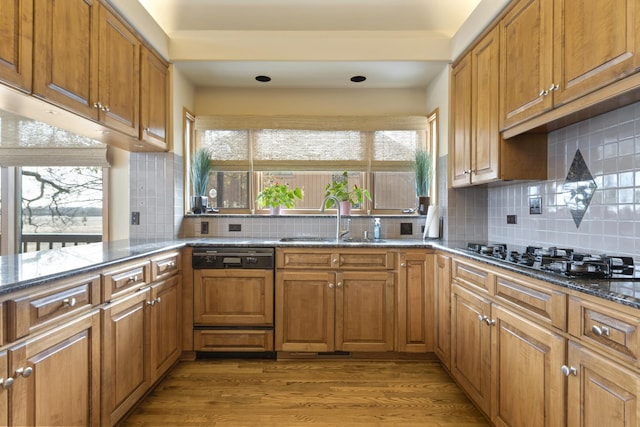 kitchen featuring sink, dishwasher, tasteful backsplash, black gas cooktop, and light wood-type flooring