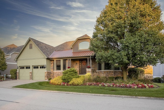 craftsman-style home with a garage and a yard