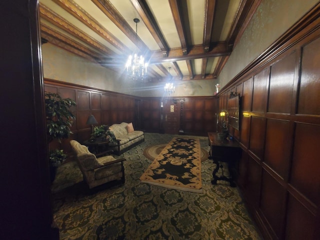 sitting room with wood walls and beamed ceiling