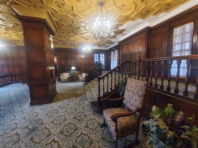 interior space with crown molding, carpet floors, wood walls, and a notable chandelier