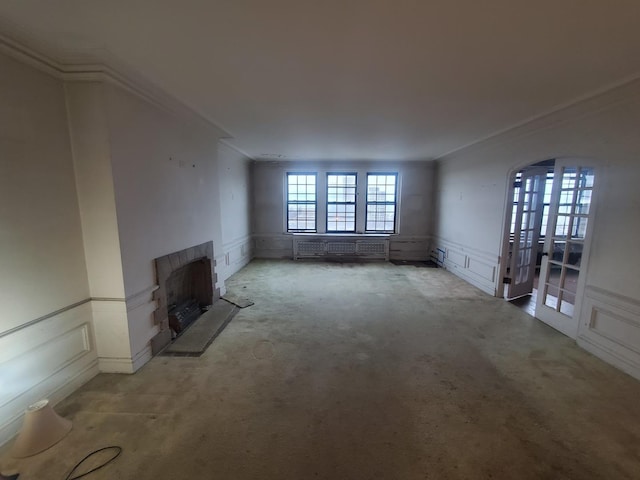 unfurnished living room with light colored carpet and crown molding