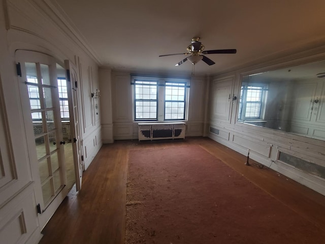 spare room with ceiling fan, dark wood-type flooring, and plenty of natural light