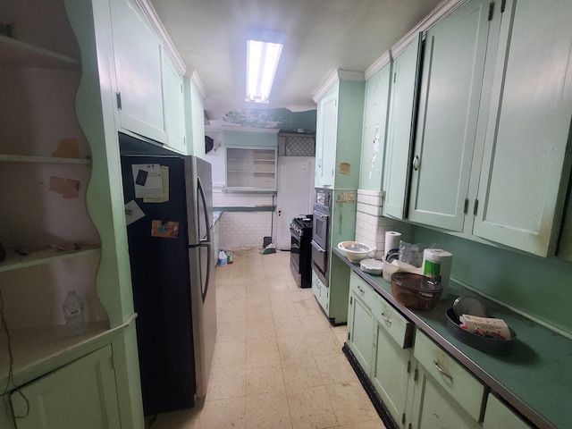 kitchen featuring white cabinets, stainless steel fridge, and green cabinetry