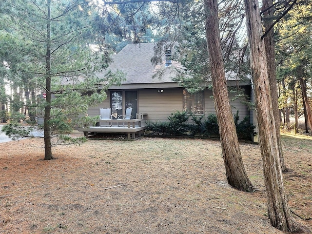 rear view of property featuring a deck