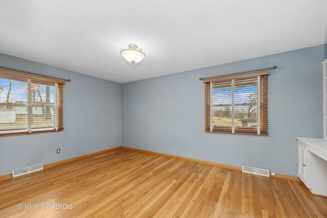 unfurnished room with light hardwood / wood-style floors