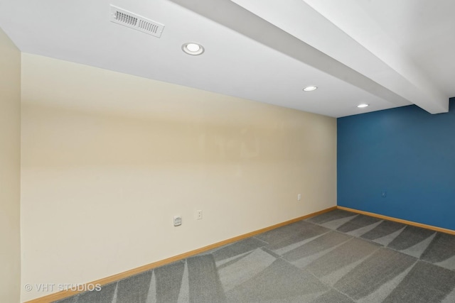 unfurnished room with carpet flooring and beamed ceiling