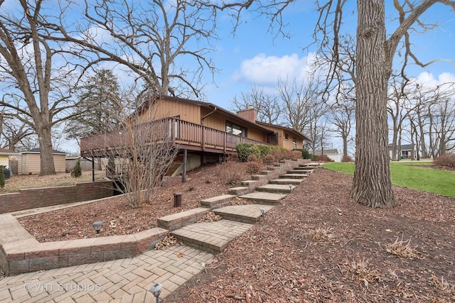 view of side of home with a wooden deck