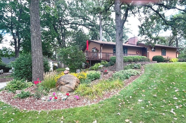 view of front of house with a front lawn and a wooden deck