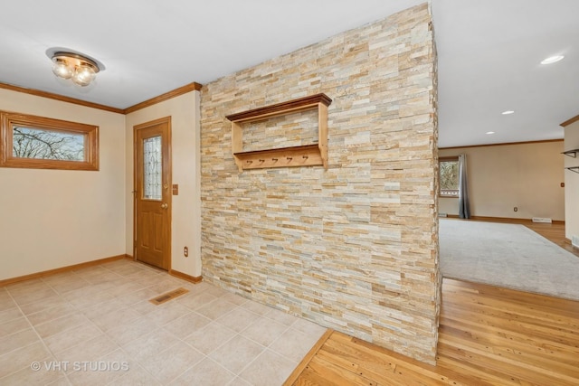 foyer entrance featuring crown molding