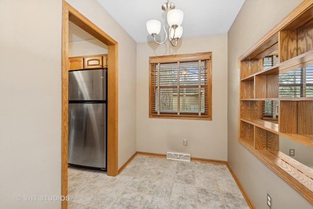 dining area with plenty of natural light and a notable chandelier