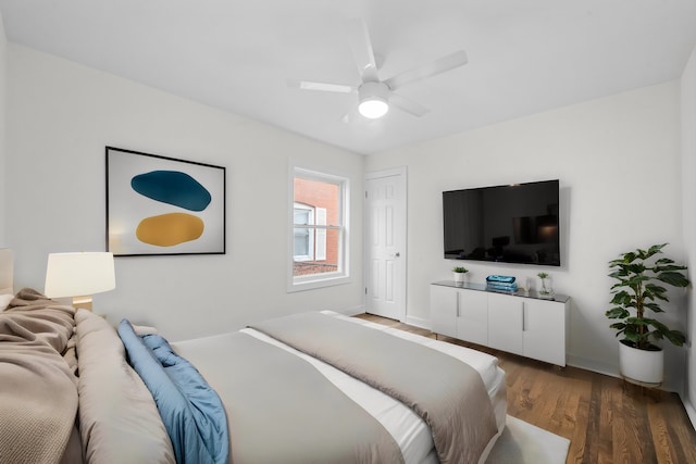 bedroom featuring ceiling fan and dark hardwood / wood-style flooring