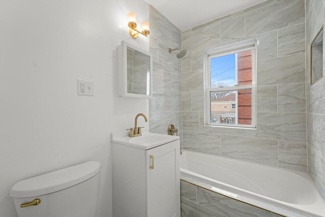 full bathroom with vanity, tiled shower / bath combo, and toilet