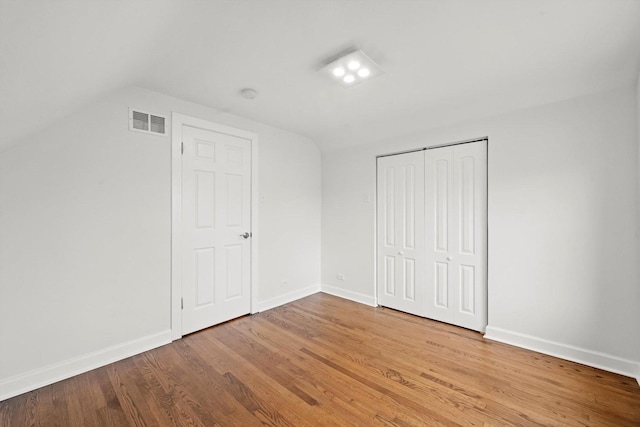 interior space with hardwood / wood-style floors and lofted ceiling