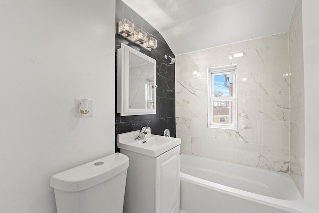 full bathroom with vanity, shower / washtub combination, vaulted ceiling, toilet, and tile walls