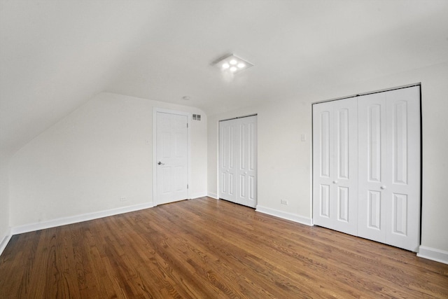 additional living space featuring hardwood / wood-style floors and vaulted ceiling