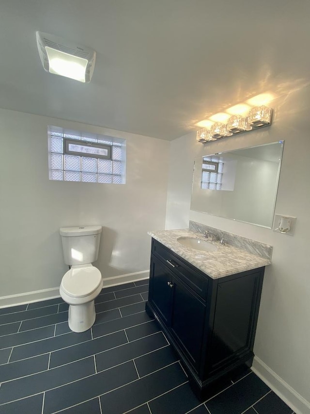 bathroom featuring tile patterned floors, vanity, and toilet