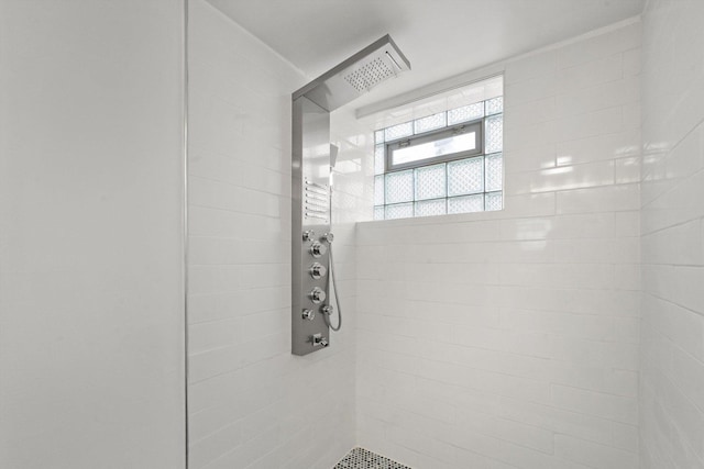 bathroom with tiled shower