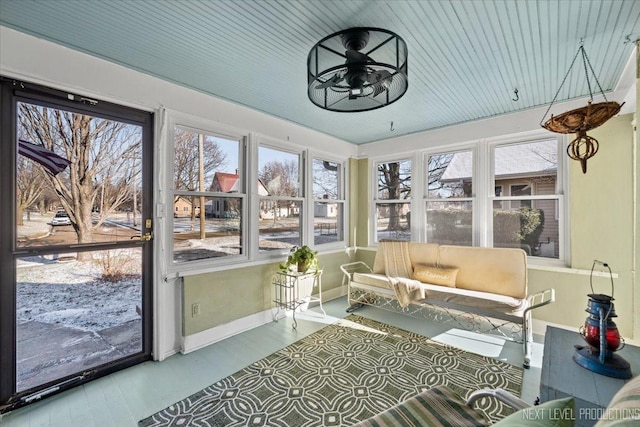 sunroom with ceiling fan and plenty of natural light