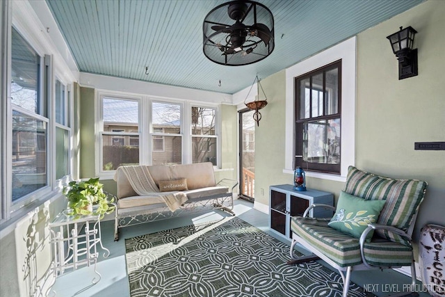 sunroom featuring ceiling fan