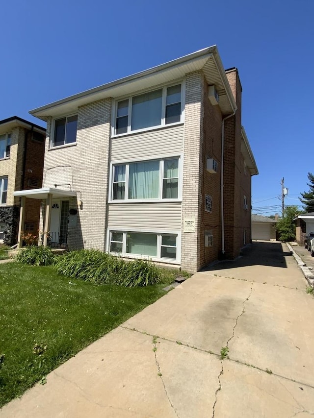 view of side of property with a lawn