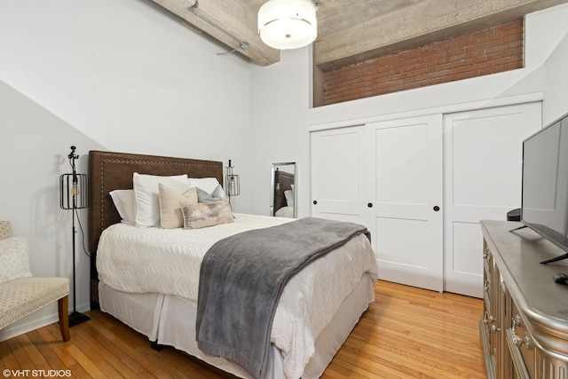 bedroom with light hardwood / wood-style flooring and a closet