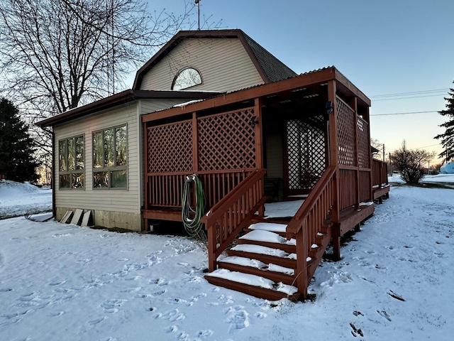 view of snow covered rear of property