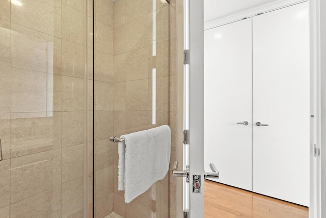 bathroom featuring an enclosed shower and wood-type flooring