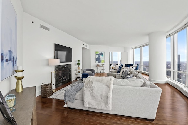 living room featuring dark hardwood / wood-style floors and floor to ceiling windows