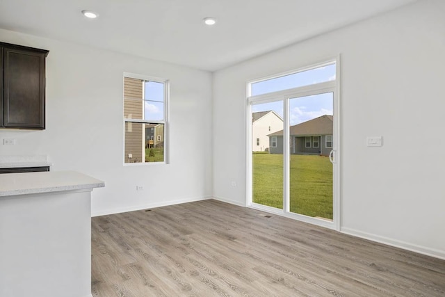 unfurnished dining area with light hardwood / wood-style floors