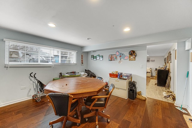 dining space with wood-type flooring