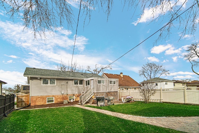 rear view of house featuring a lawn