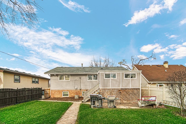 rear view of house with a patio area and a lawn