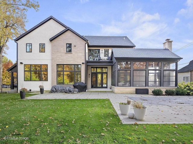 back of house with a yard, a patio, a balcony, and a sunroom