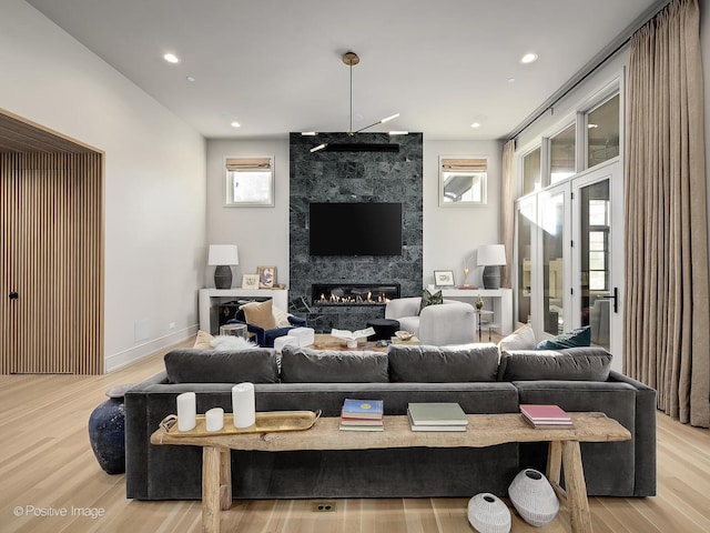 living room featuring a fireplace and light hardwood / wood-style flooring