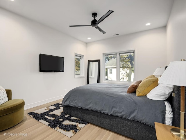 bedroom with ceiling fan and hardwood / wood-style flooring